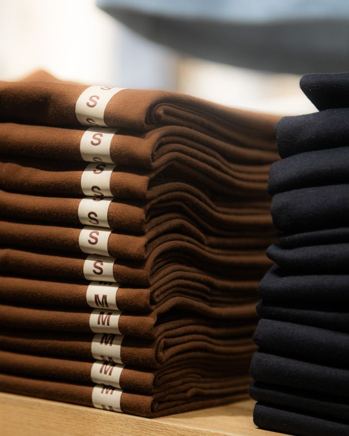 Neatly folded brown and black shirts in a retail store in Hà Nội, Vietnam.